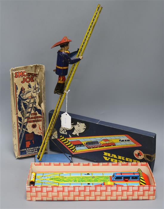 A Marx Smokey Joe climbing fireman tin plate toy and a Rakoda Vonat tin plate toy